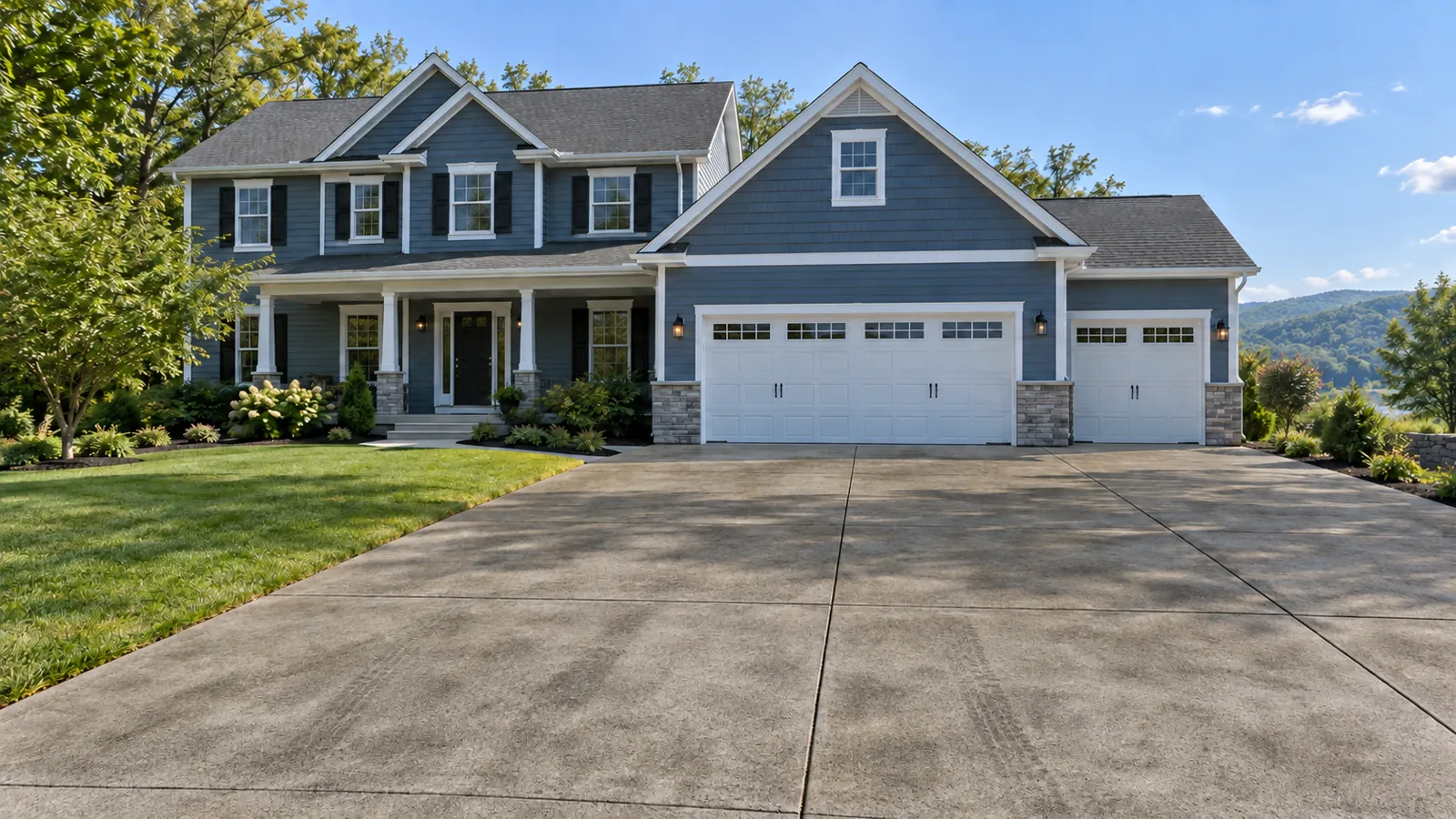 Blue-gray Hudson Valley home with a broad residential driveway